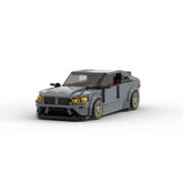 Gray car model made of interlocking bricks on a white background